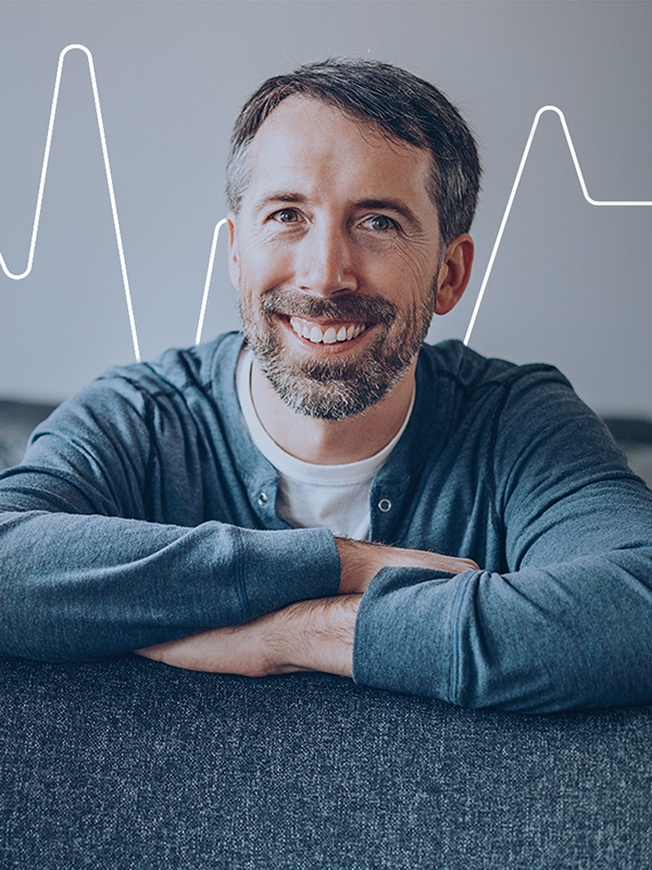 Symbolic photo of a relaxed man and stable heartbeat graphic, representing the calming effects of the Anxiety Kit.